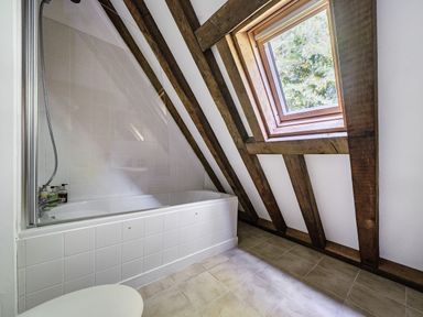 A bathroom with a bathtub and shower at Cabin Sleeps 6 with Parking and Patio in Tremail near Camelford