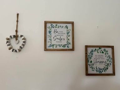 Decorative wall with framed quotes and a heart hanging at a property in Nebo near Penygroes