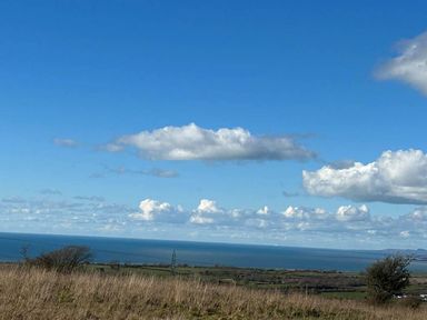 A view of the sea and clouds in the landscape near Nebo near Penygroes