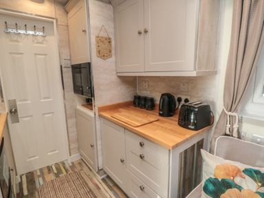 A kitchen with cabinets, appliances and accessories at Owls Roost in Robin Hood’s Bay