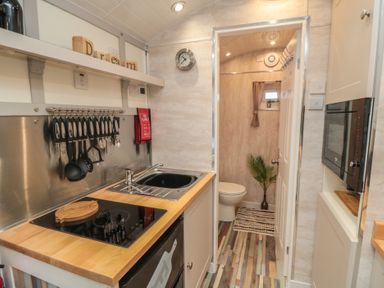 A kitchen with a sink and stove at Owls Roost in Robin Hood’s Bay
