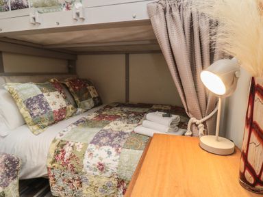 A bedroom with a bed and bedside table at Owls Roost in Robin Hood’s Bay