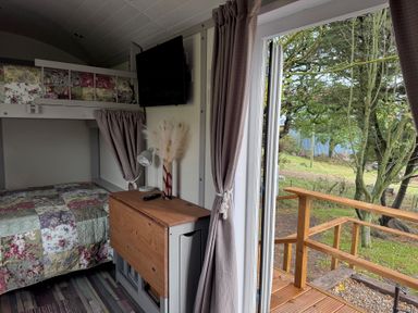 A bedroom with a bed and television at Owls Roost in Robin Hood’s Bay