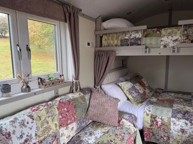 A bedroom with bunk bed and sofa at Owls Roost in Robin Hood’s Bay