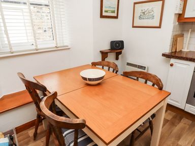A dining room with a table and chairs at Spinnaker