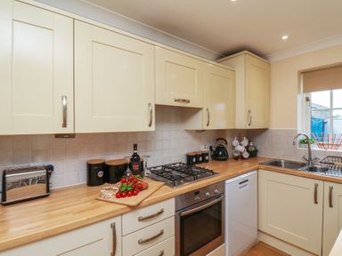A kitchen with cabinets and appliances at The Cosy Haven in Malton