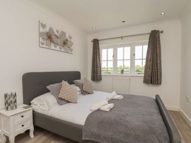 A bedroom with a bed and window at The Cosy Haven in Malton