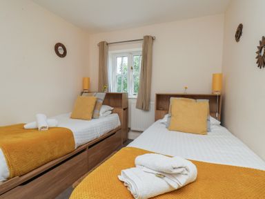 A bedroom with two beds and a window at The Cosy Haven in Malton