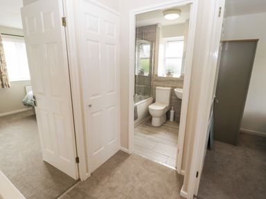 A bathroom with a bathtub, toilet, and sink at 7 Cwrt Y Cadno, Llantwit Major