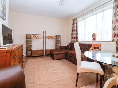 A living room with a sofa and dining table at Westgate Willows in Nafferton