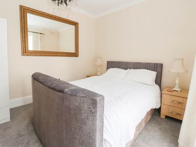 A bedroom with a bed and nightstands at Westgate Willows Nafferton