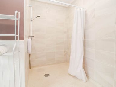 A shower area with a curtain and towel rack at Westgate Willows in Nafferton