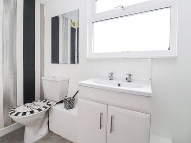 A bathroom with a toilet and sink at Westgate Willows Nafferton
