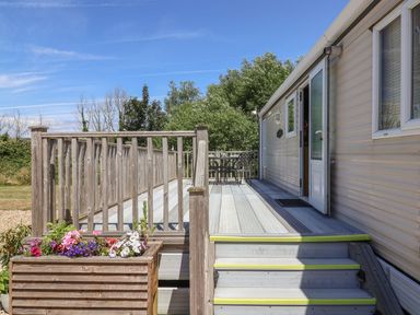 An outdoor area with a deck and seating at The Hideaway in Portesham