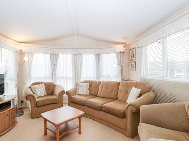 A living room with a sofa and armchair at The Hideaway in Portesham