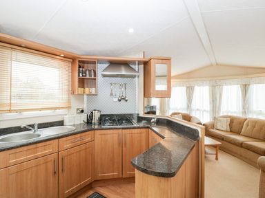 A kitchen with cabinets and appliances at The Hideaway in Portesham