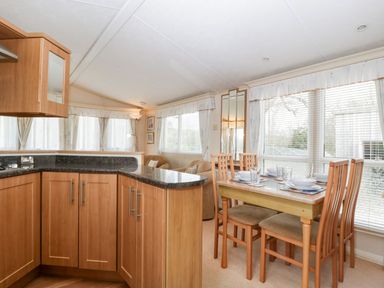 A kitchen with a dining table and chairs at The Hideaway in Portesham