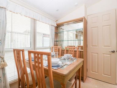 A dining room with a table and chairs at The Hideaway in Portesham