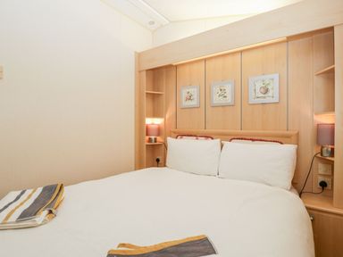 A bedroom with a double bed and bedside lamps at The Hideaway in Portesham