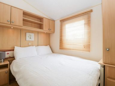 A bedroom with a bed and bedside table at The Hideaway in Portesham