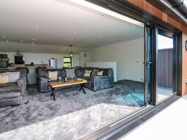 A living room with a sofa and coffee table at Sycamore Cottage in Frizington
