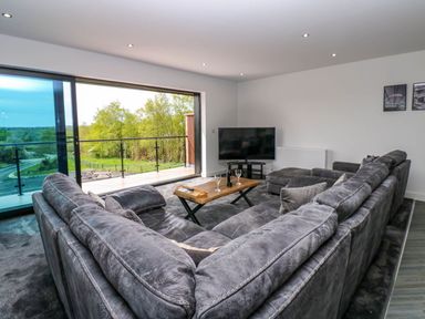 A living room with a sofa and coffee table at Sycamore Cottage in Frizington