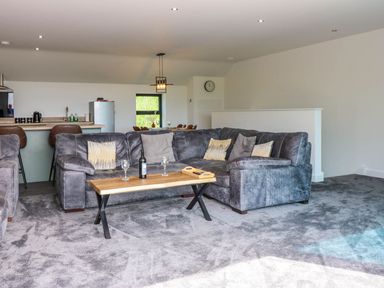 A living room with a sofa and coffee table at Sycamore Cottage in Frizington