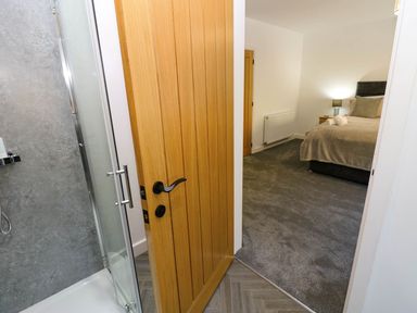 A bedroom with a shower visible from the doorway at Silver Birch Cottage in Frizington