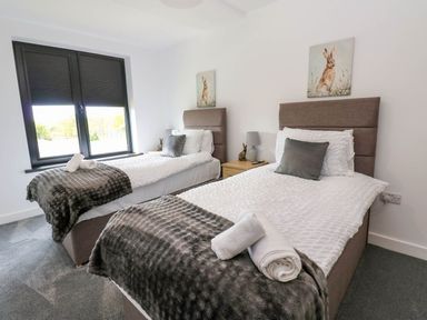 A bedroom with two single beds at Silver Birch Cottage in Frizington