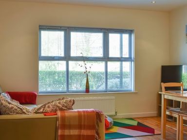 A living room with a sofa and a table at Admirals Rest in Weymouth