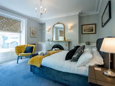 A bedroom with a bed and a sofa at Gwynfryn House in Llanbedr