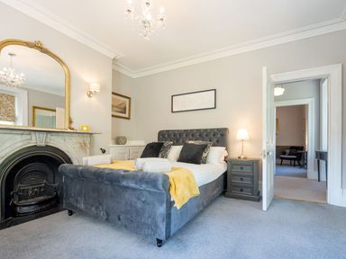 A bedroom with a bed and dresser at Gwynfryn House in Llanbedr