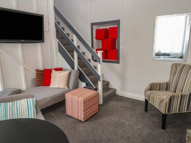 A living room with a sofa and television at 1 St. Day Road in Redruth
