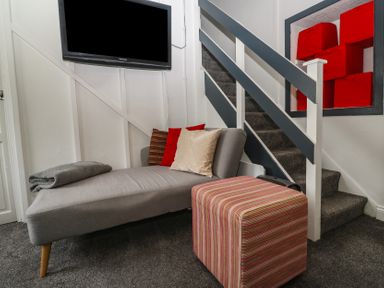 A living room with a sofa and television at 1 St. Day Road in Redruth