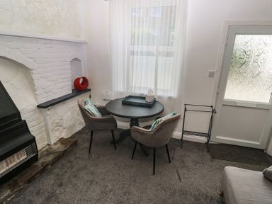 A living room with a table and chairs at 1 St. Day Road in Redruth