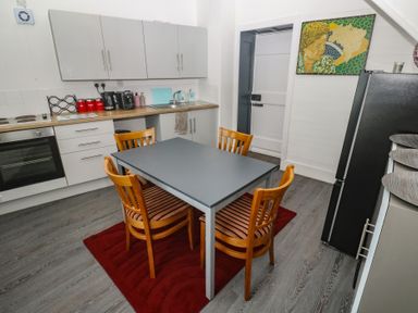 A kitchen with a table and chairs at 1 St. Day Road in Redruth