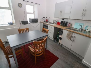 A kitchen with a dining table and chairs at 1 St. Day Road Redruth