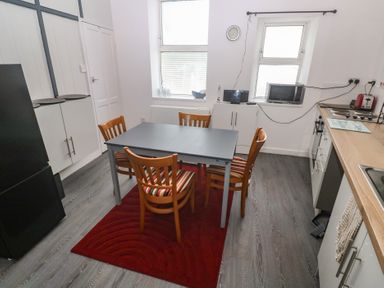 A kitchen with a table and chairs at 1 St. Day Road in Redruth