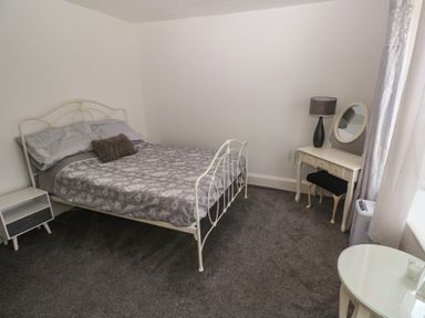 A bedroom with a bed and nightstand at 1 St. Day Road Redruth