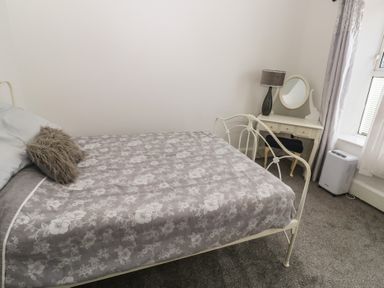 A bedroom with a bed and a dresser at 1 St. Day Road, Redruth