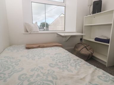 A bedroom with a bed and shelf at 1 St. Day Road Redruth