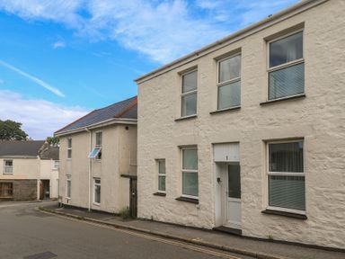 A building with windows and door on a street at 1 St. Day Road Redruth
