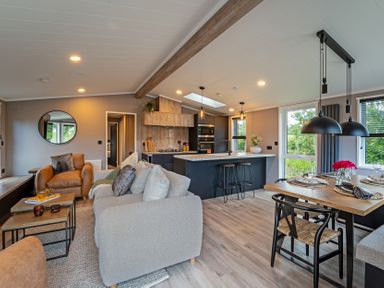 A living room and kitchen area at Hideaway Lodge Llanfechell