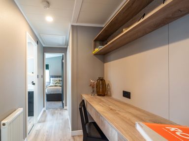 A hallway with a desk and shelves at Hideaway Lodge in Llanfechell