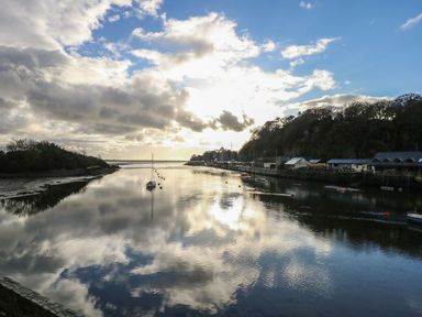 A river with boats and reflections at Seafarer's Haven Porthmadog