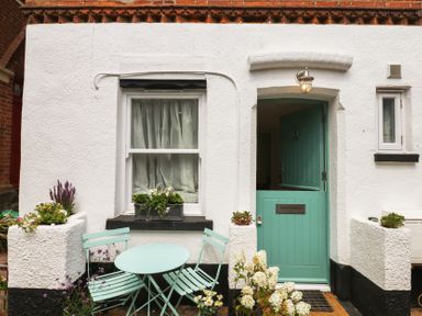 A front door with a window and seating at Tower View Cottage in Lympstone