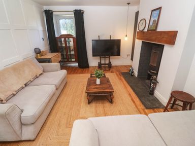 A living room with a sofa and television at The Lookout in Redruth