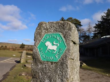 A sign for Dartmoor National Park near a road at The Hayloft at Manaton Manaton