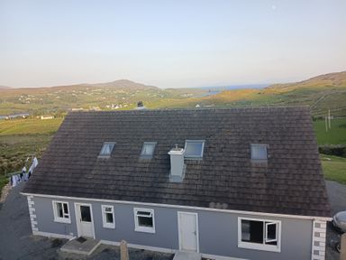 A house with a grey exterior and chimney at Sliabh League Mountain Lodge TEILEANN near Kilcar, County Donegal