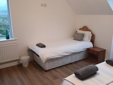 A bedroom with a single bed and nightstand at Sliabh League Mountain Lodge TEILEANN near Kilcar, County Donegal